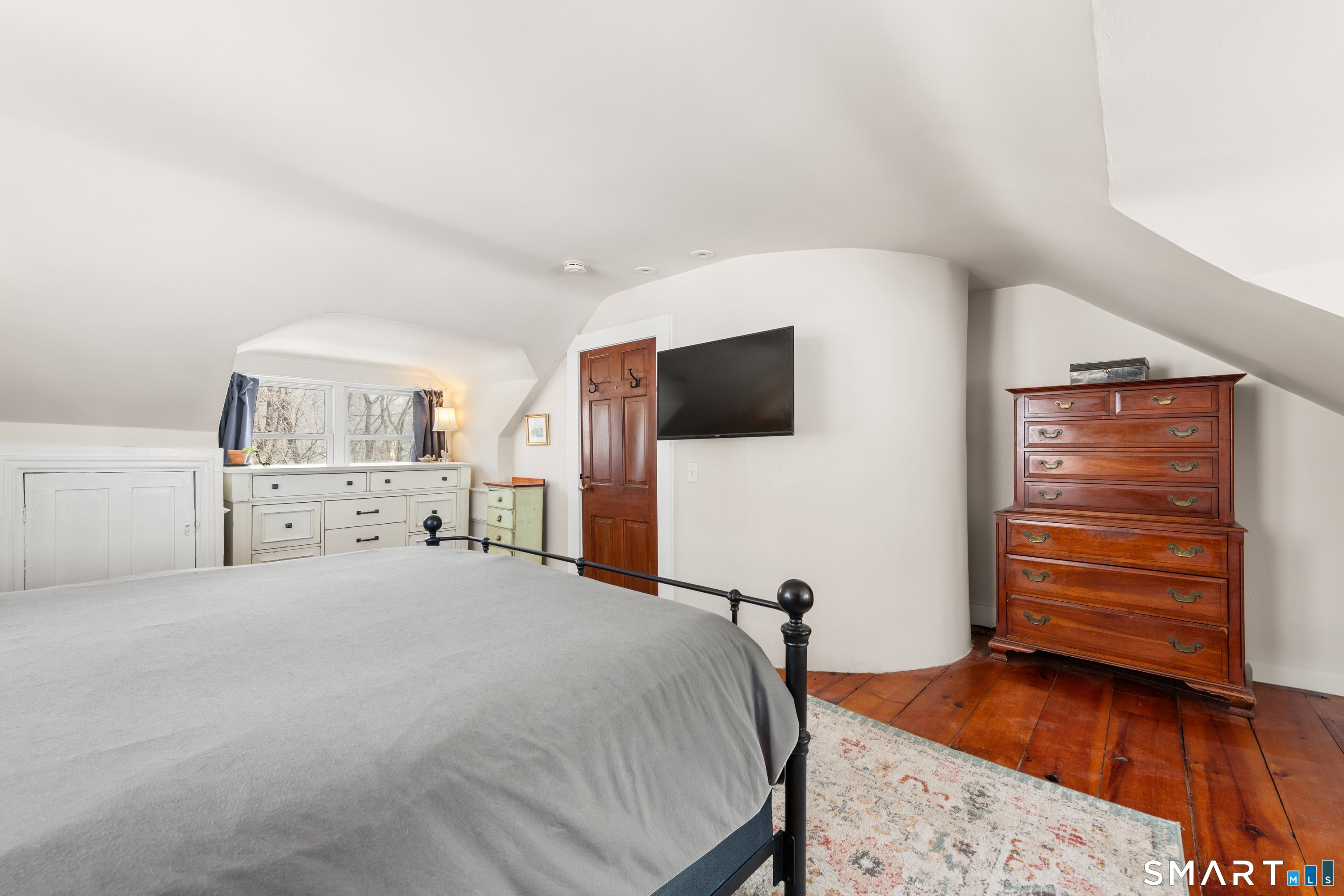 138 Putnam Park Road Bethel, CT 06801 - Photo 35 of 40 a bedroom with a bed and a flat screen tv