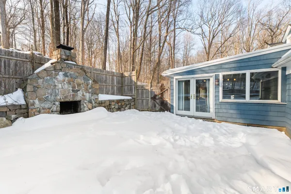 a view of a house with a yard covered in snow