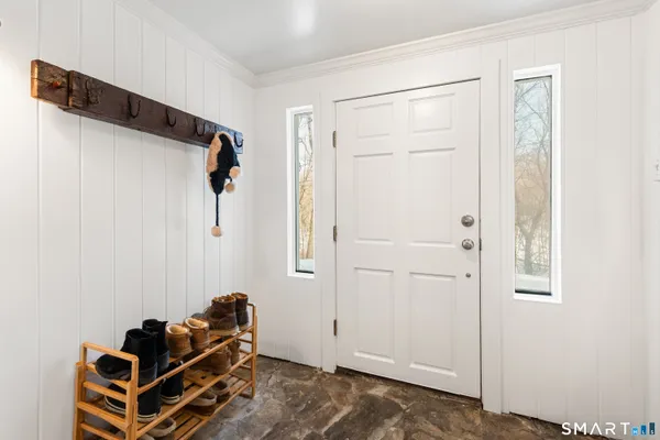 a view of entryway and hall with wooden floor