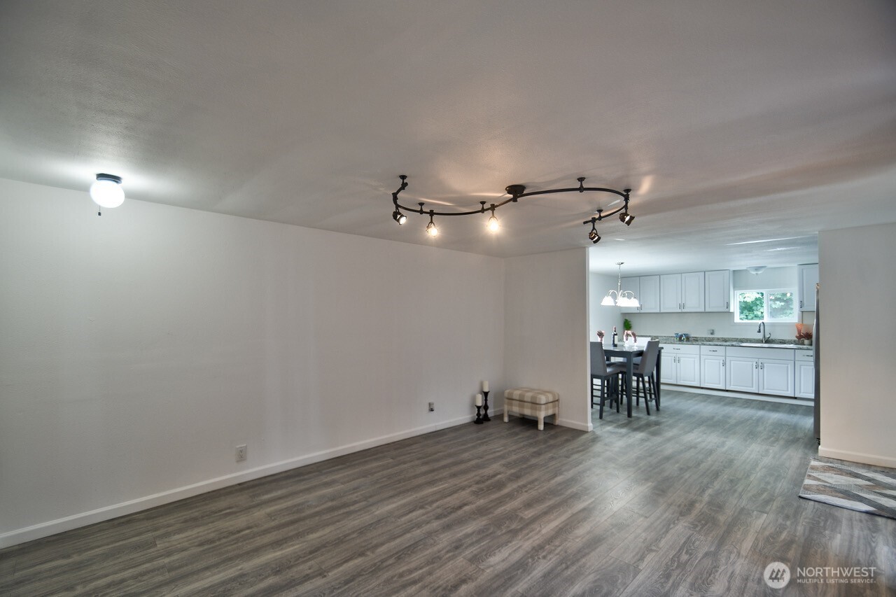 15503 Cedar Park Road Southeast, Unit 14 Olalla, WA 98359 - Photo 7 of 14 a view of a room with wooden floor a ceiling fan and windows
