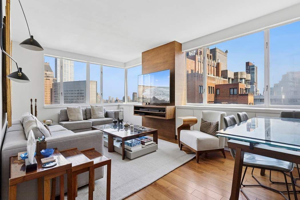 a living room with furniture and a kitchen view
