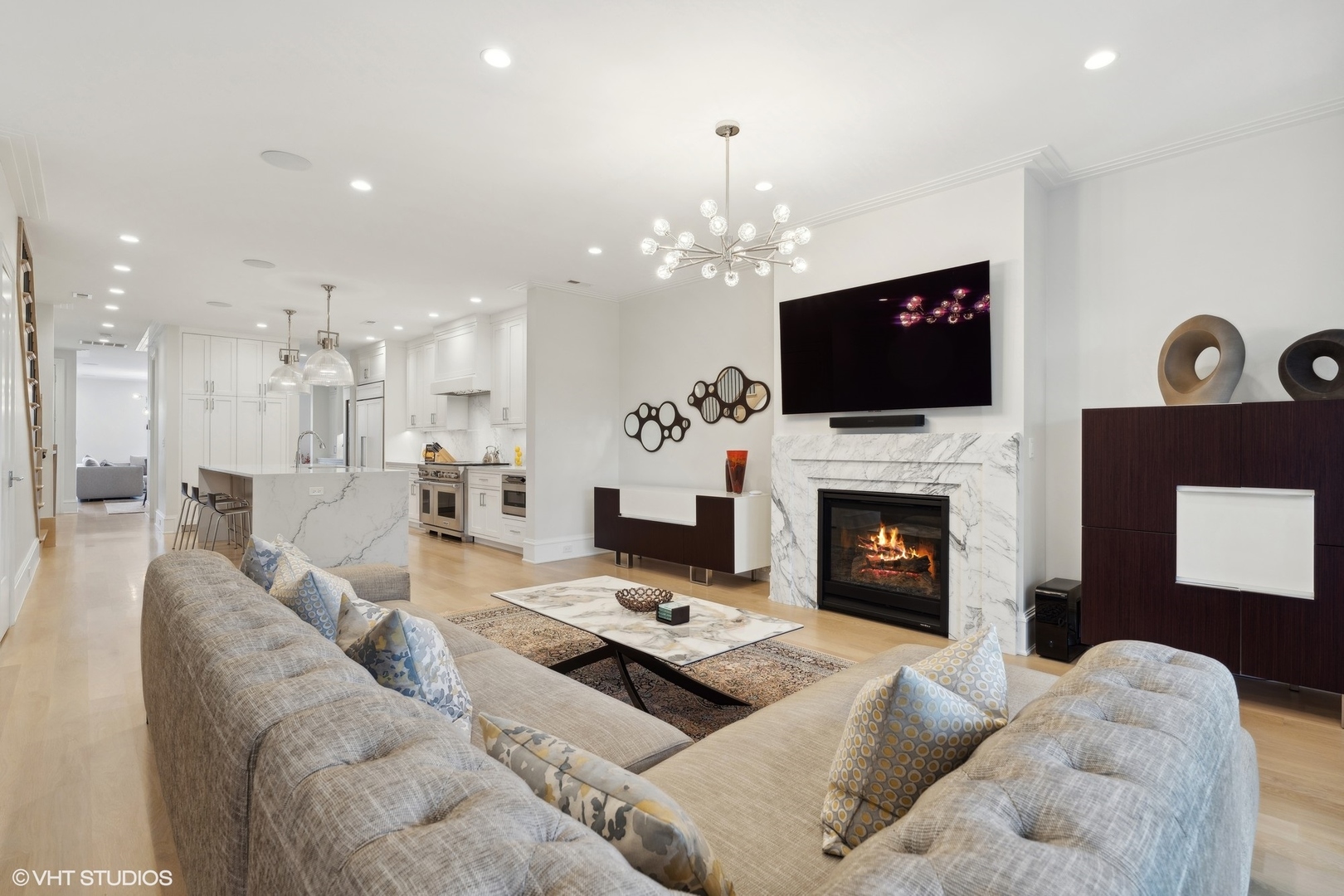 1940 North Mohawk Street, Unit 3 Chicago, IL 60614 - Photo 2 of 33 a living room with furniture a fireplace and a flat screen tv