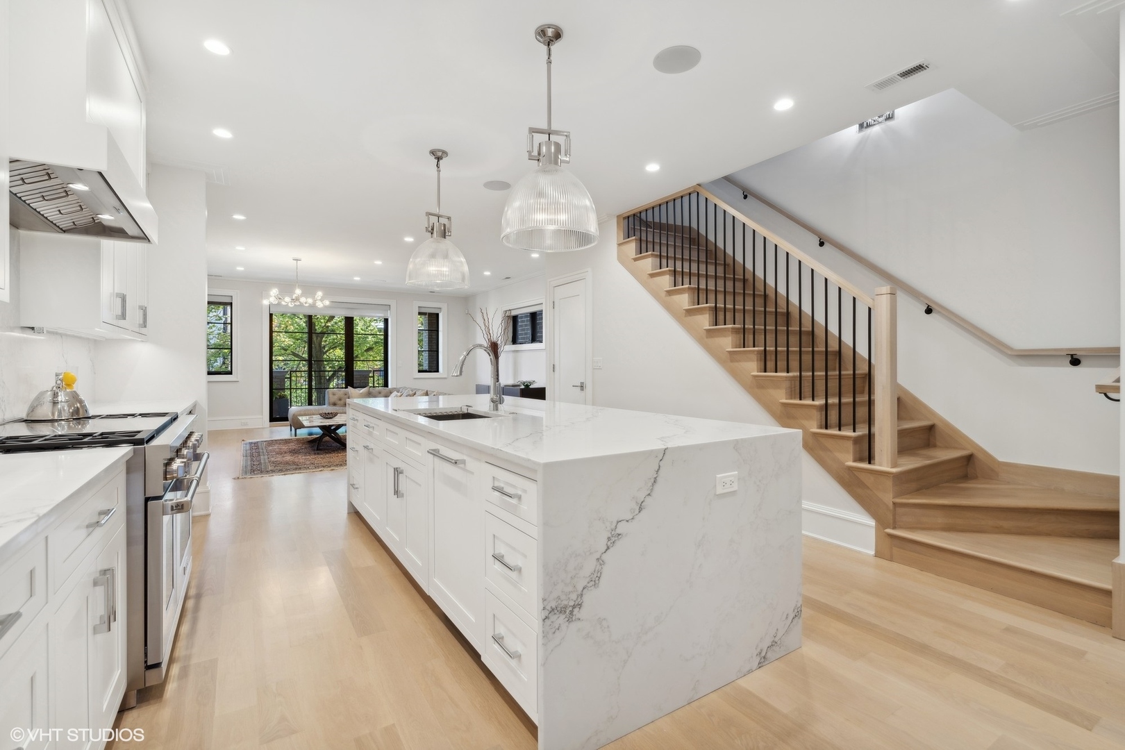 1940 North Mohawk Street, Unit 3 Chicago, IL 60614 - Photo 3 of 33 a large white kitchen with wooden floor and a sink