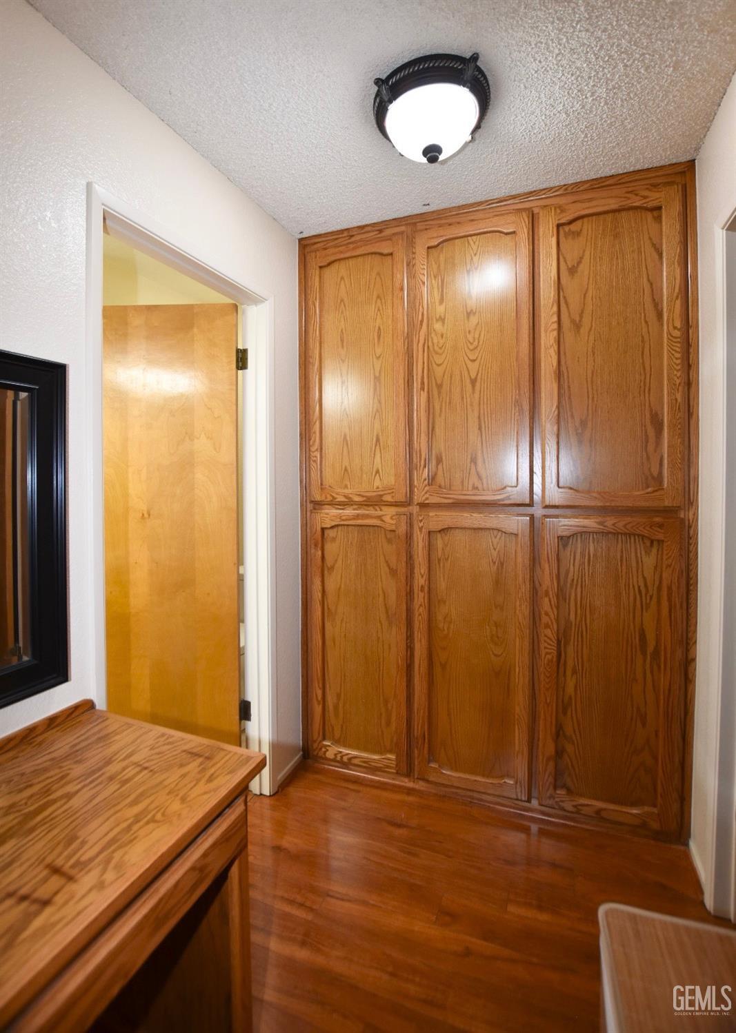 Undisclosed Address Tehachapi, CA 93561 - Photo 7 of 16 an empty room with wooden floor and closet area