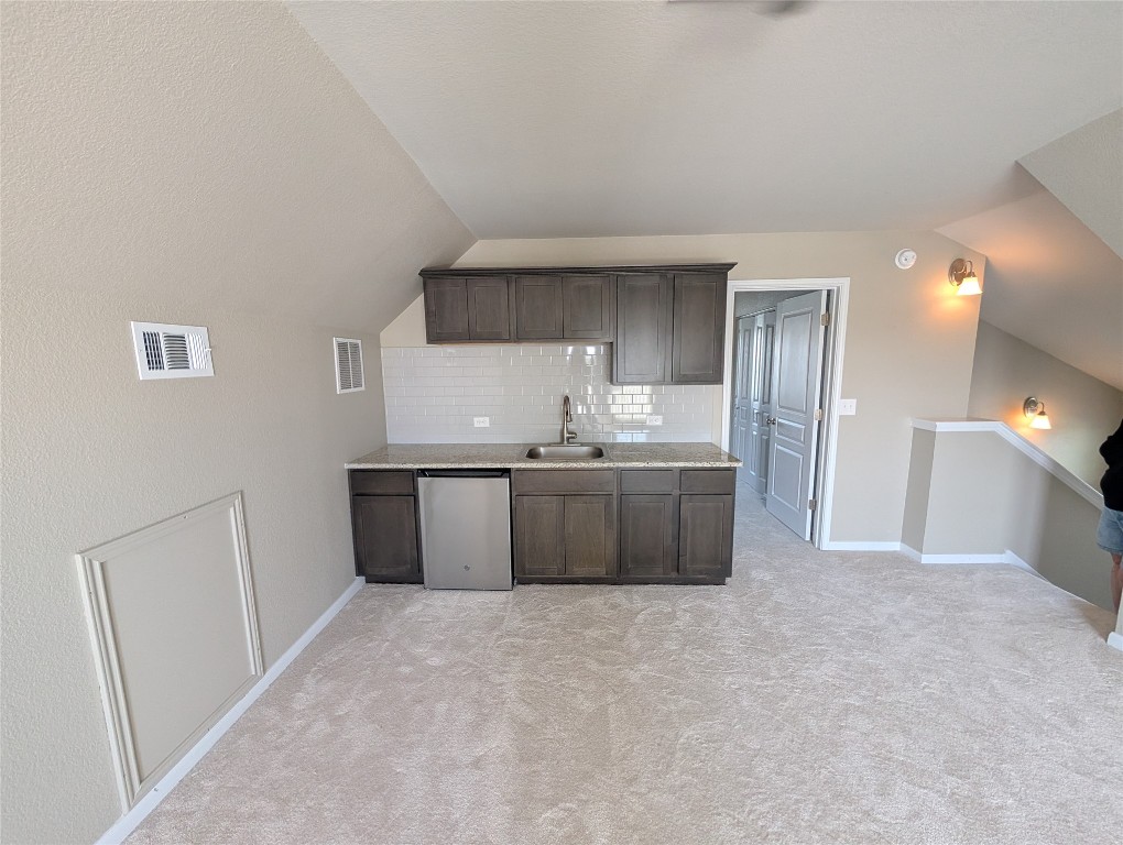 1269 Nevarez Kyle, TX 78640 - Photo 25 of 30 a kitchen with a sink a refrigerator and cabinets