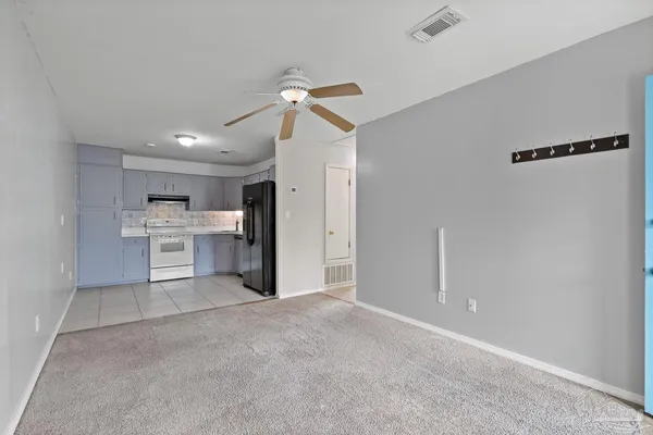 a view of a kitchen with a sink and a refrigerator