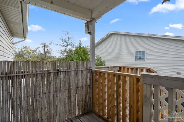 a view of a house with wooden fence