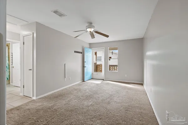 a view of empty room with ceiling fan