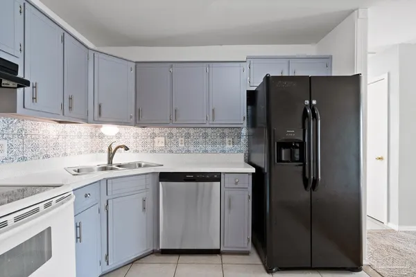 a kitchen with a sink and a refrigerator