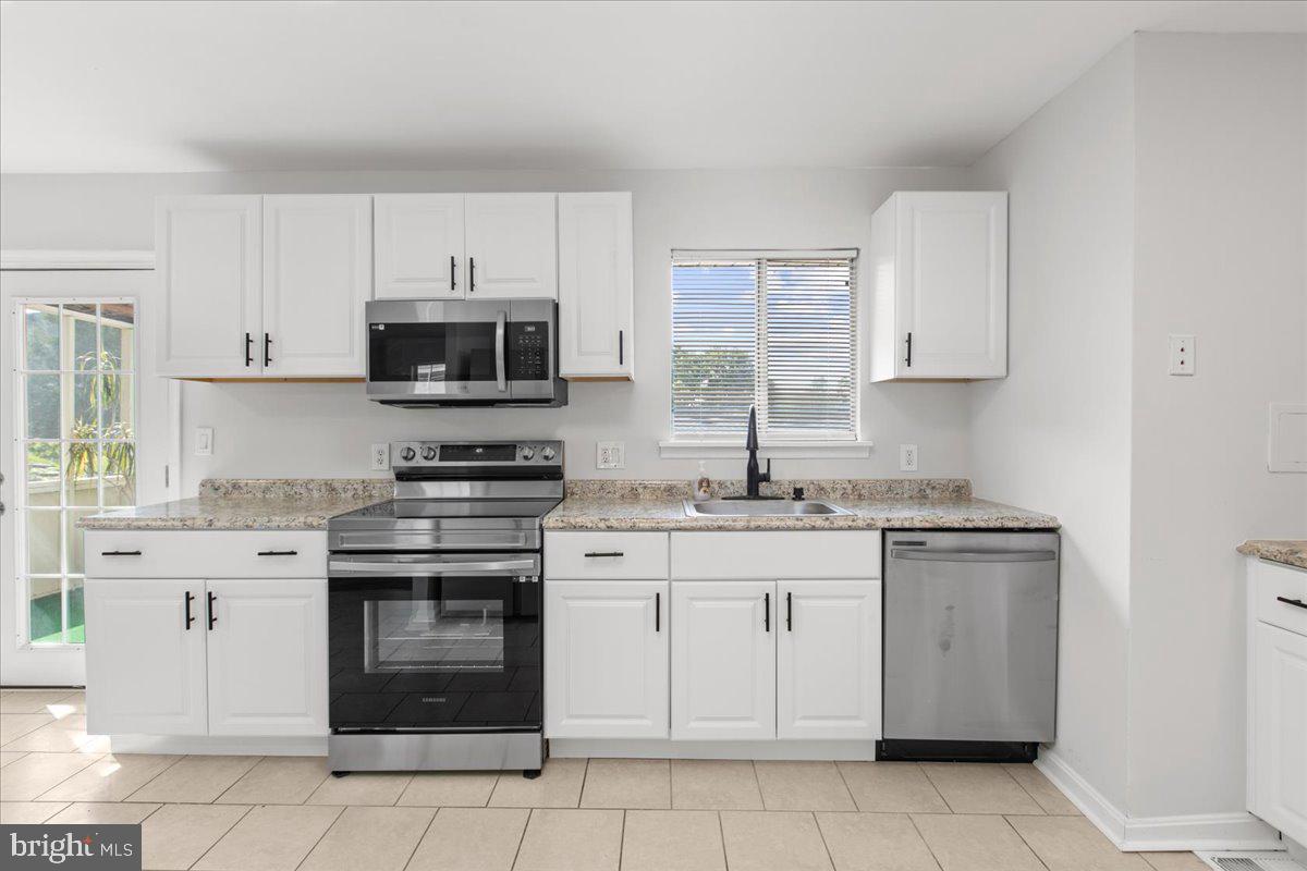 325 Londontown Road Edgewater, MD 21037 - Photo 5 of 34 a kitchen with cabinets stainless steel appliances and a sink