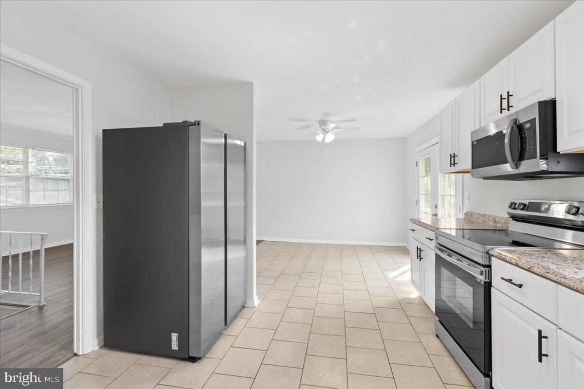 325 Londontown Road Edgewater, MD 21037 - Photo 7 of 34 a kitchen with stainless steel appliances granite countertop a refrigerator and a stove top oven