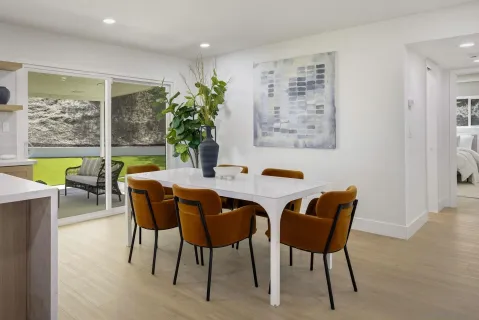 a dining room with furniture and window