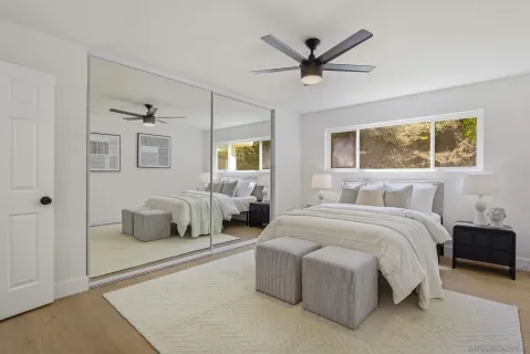 a spacious bedroom with a bed and window