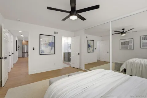 a bedroom with a bed and a chandelier