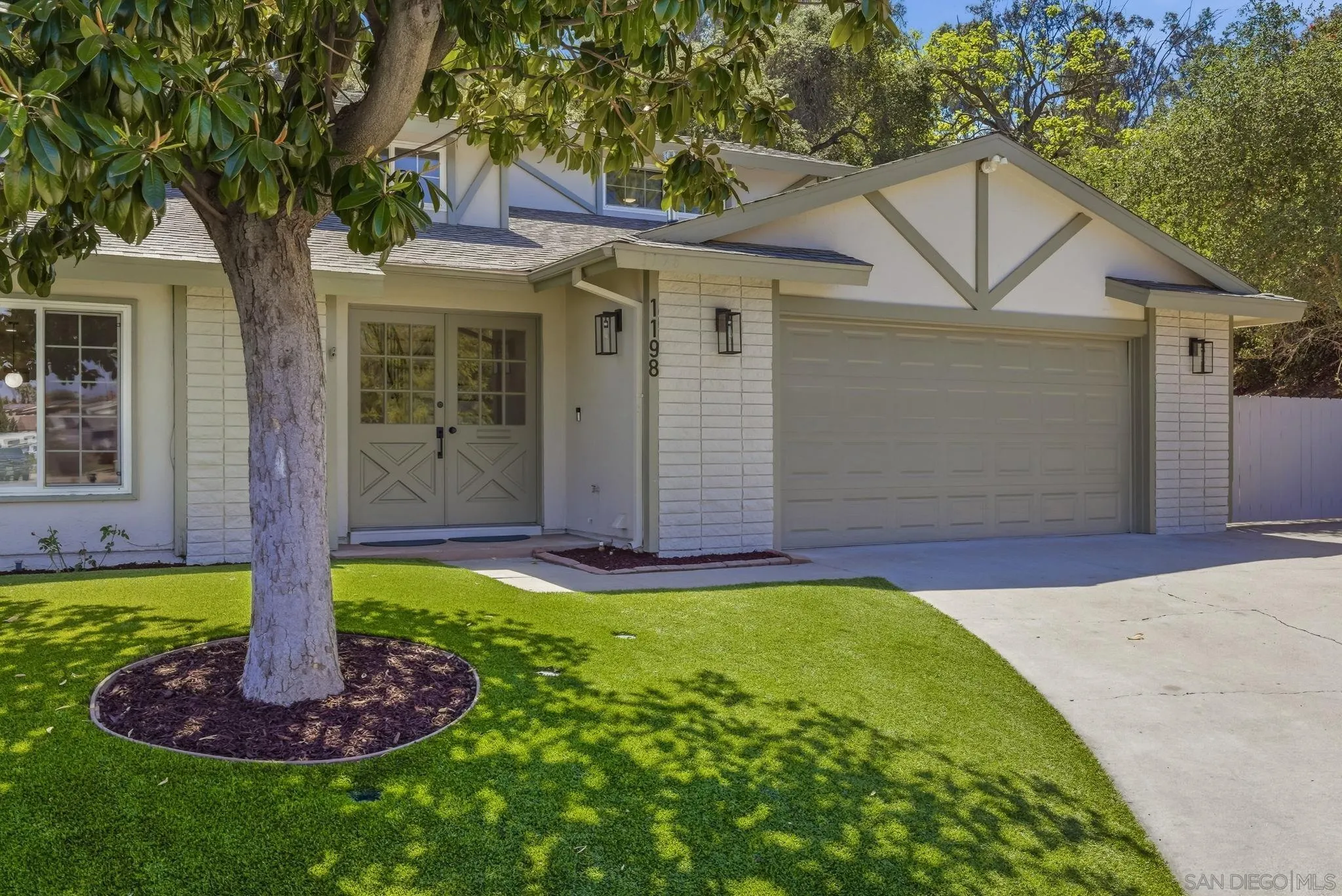1198 Benjamin Place El Cajon, CA 92020 - Photo 2 of 38 a front view of a house with a yard and trees