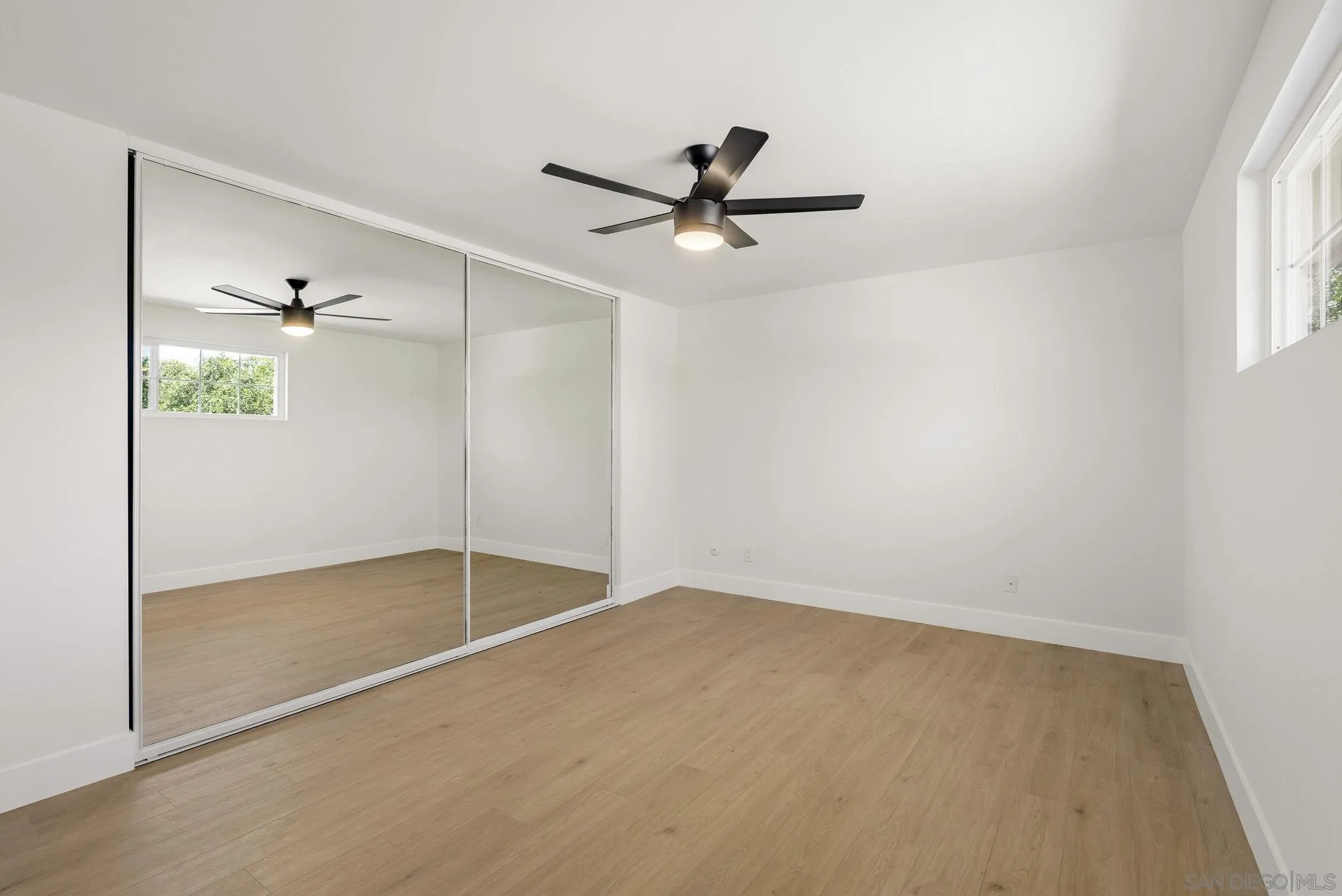 1198 Benjamin Place El Cajon, CA 92020 - Photo 21 of 38 an empty room with windows and fan