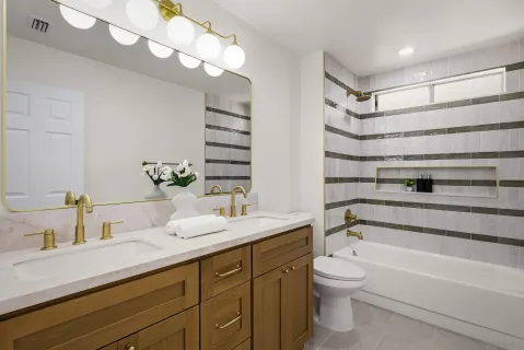 a bathroom with a double vanity sink mirror and toilet