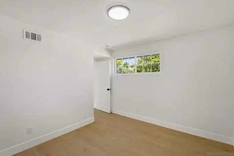 an empty room with windows and closet