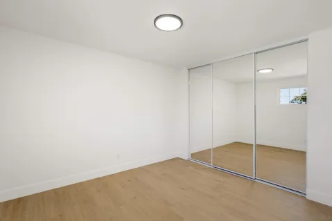 a view of a house with a big yard and large trees