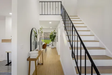 a view of entryway and hall with wooden floor