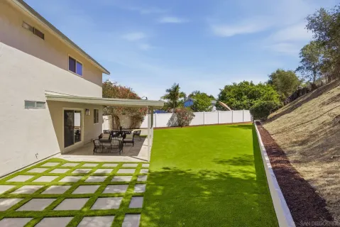 an aerial view of residential house with green space