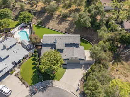an aerial view of residential houses with outdoor space