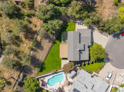 an aerial view of residential building with green space