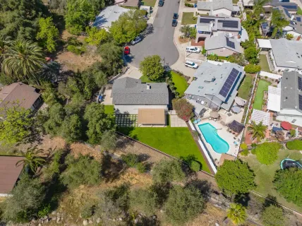 an aerial view of residential houses with city view