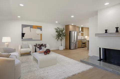 a living room with furniture and kitchen view
