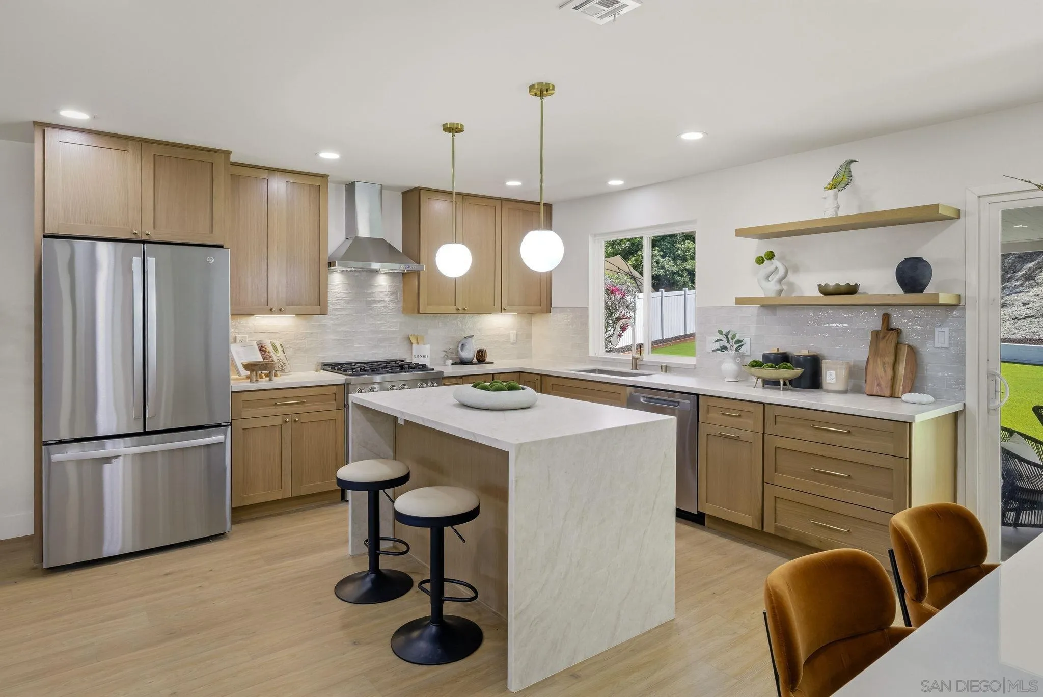 1198 Benjamin Place El Cajon, CA 92020 - Photo 8 of 38 a kitchen with white cabinets and stainless steel appliances