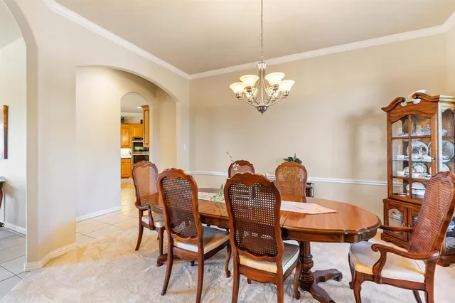 a dining room with furniture and chandelier