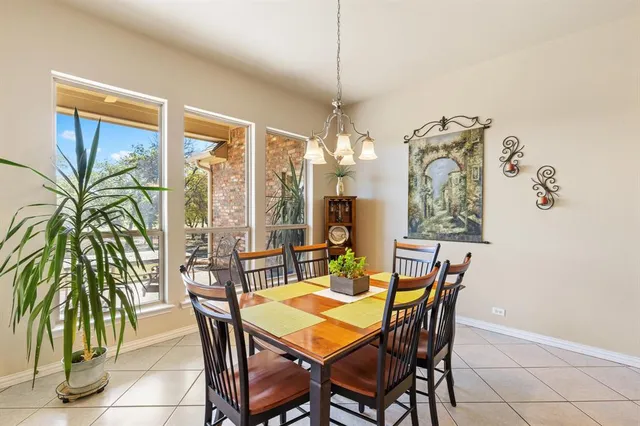 a view of a dining room with furniture and chandelier