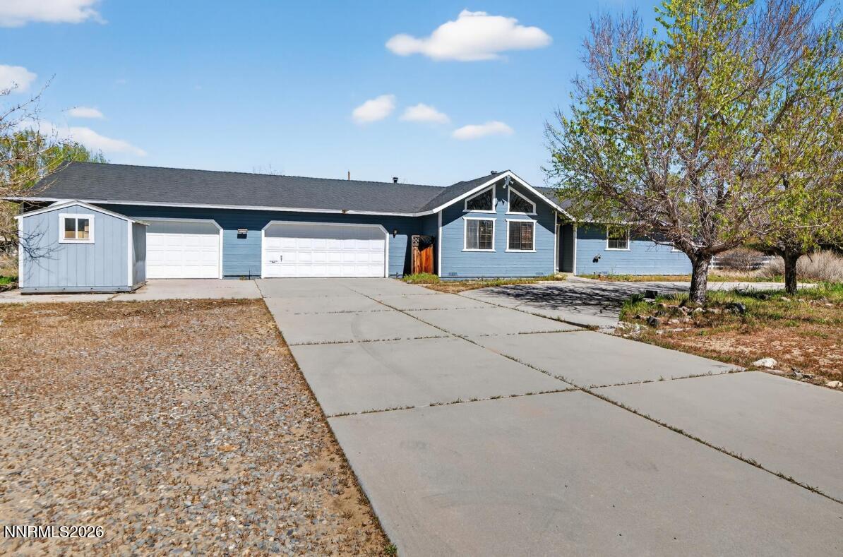 1254 Stephanie Way Minden, NV 89423 - Photo 1 of 30 a front view of a house with a yard and garage