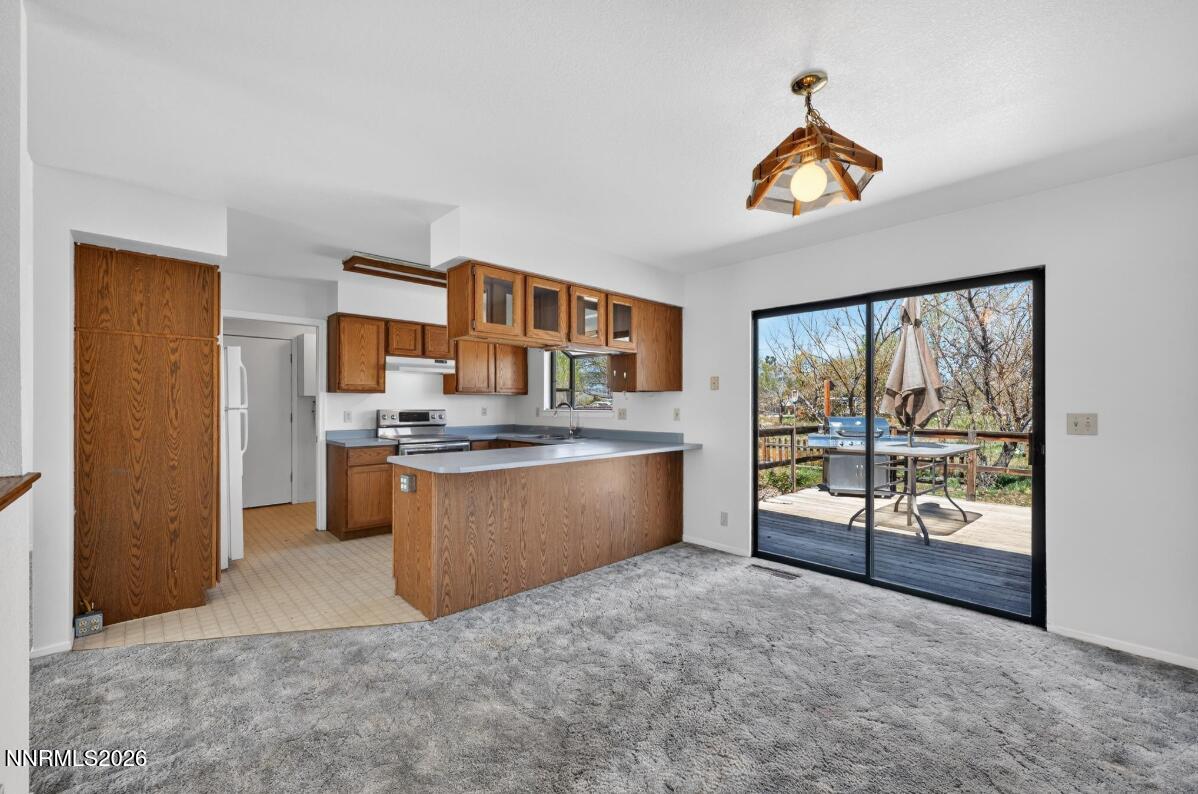1254 Stephanie Way Minden, NV 89423 - Photo 12 of 30 a large kitchen with stainless steel appliances granite countertop a stove and a refrigerator