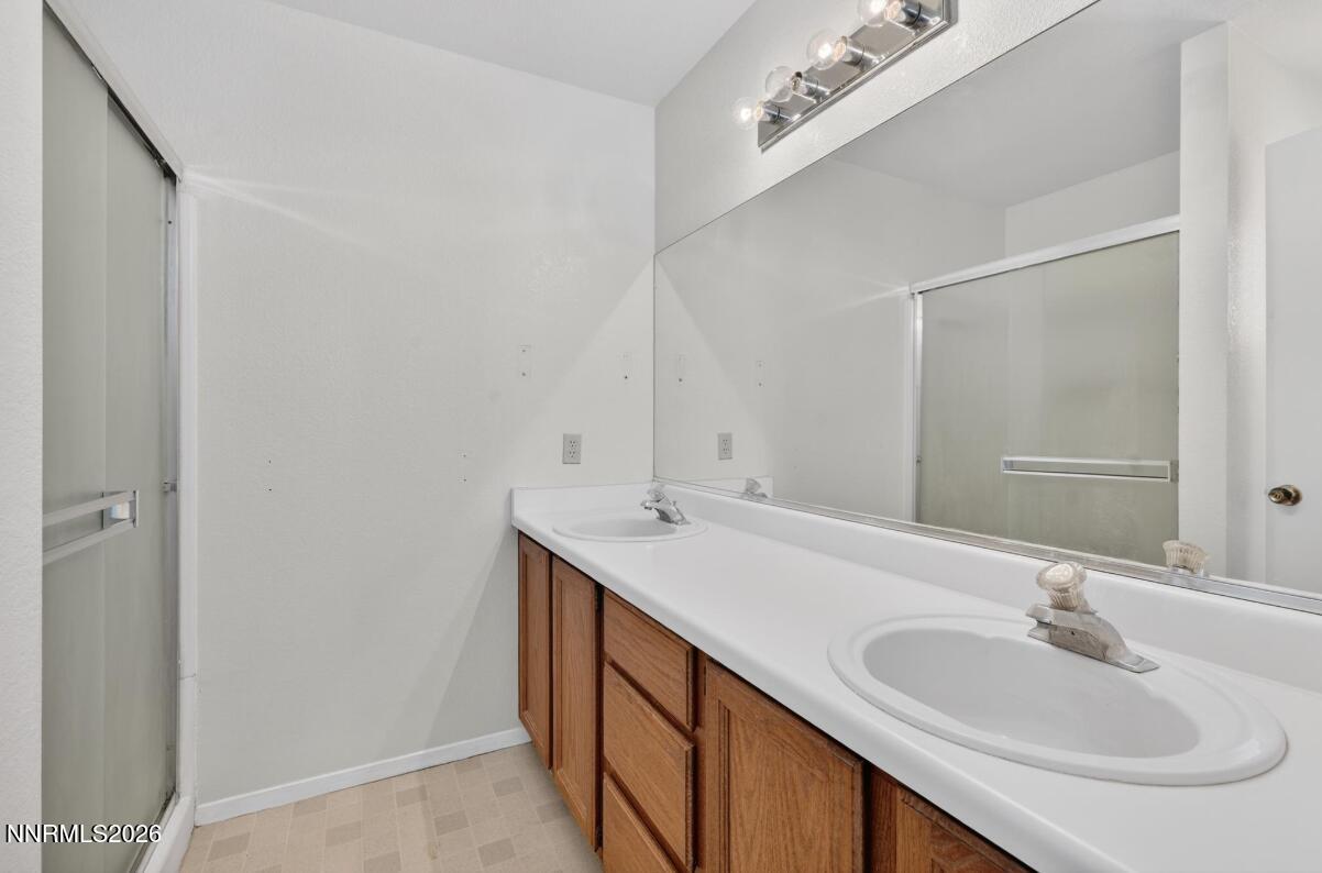 1254 Stephanie Way Minden, NV 89423 - Photo 18 of 30 a bathroom with a sink and a mirror