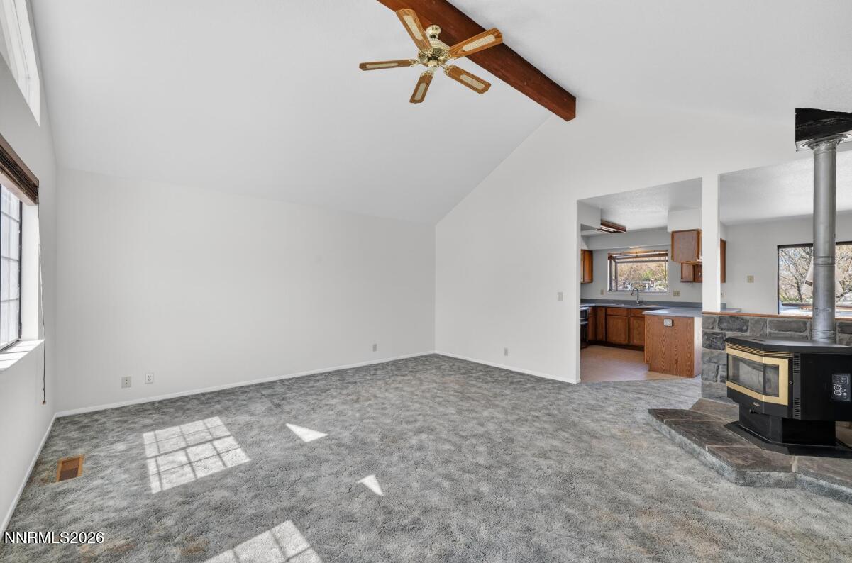 1254 Stephanie Way Minden, NV 89423 - Photo 8 of 30 an empty room with kitchen view and a window