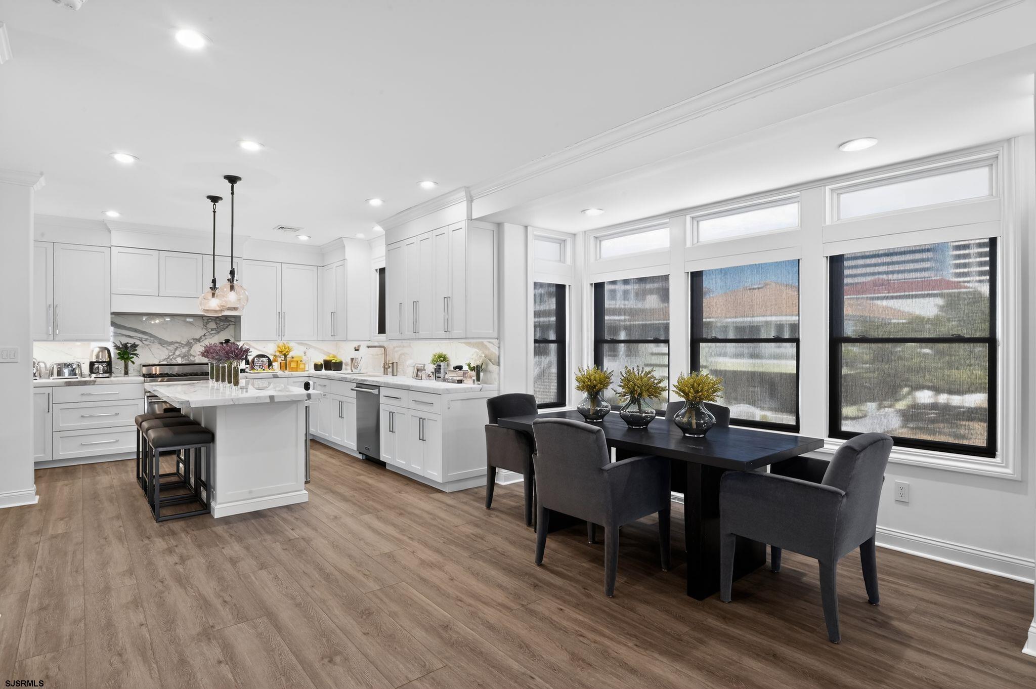 146 Ridgeway Avenue Atlantic City, NJ 08401 - Photo 11 of 59 a kitchen with a table chairs stove and kitchen island