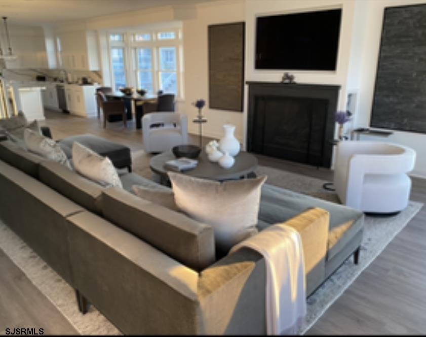 146 Ridgeway Avenue Atlantic City, NJ 08401 - Photo 15 of 59 a living room with furniture a fireplace and a flat screen tv