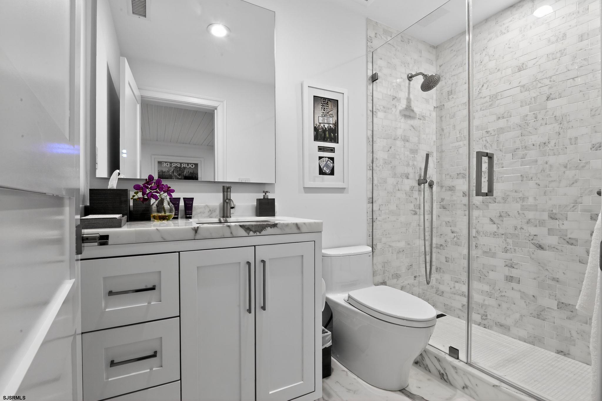 146 Ridgeway Avenue Atlantic City, NJ 08401 - Photo 27 of 59 a bathroom with a sink toilet vanity and shower