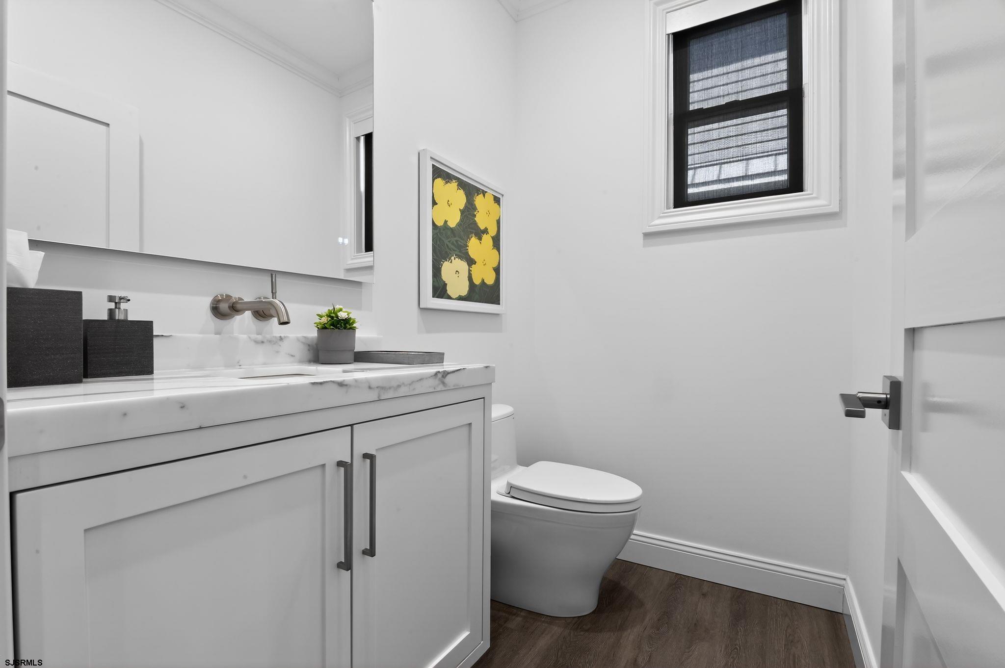 146 Ridgeway Avenue Atlantic City, NJ 08401 - Photo 28 of 59 a bathroom with a toilet sink and mirror