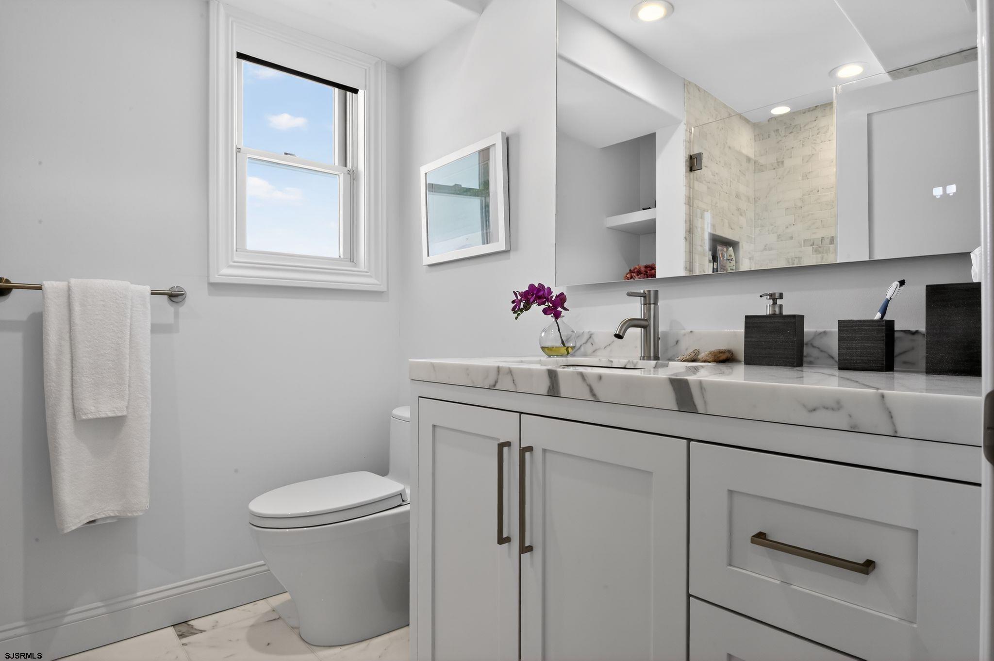 146 Ridgeway Avenue Atlantic City, NJ 08401 - Photo 32 of 59 a bathroom with a toilet sink and mirror