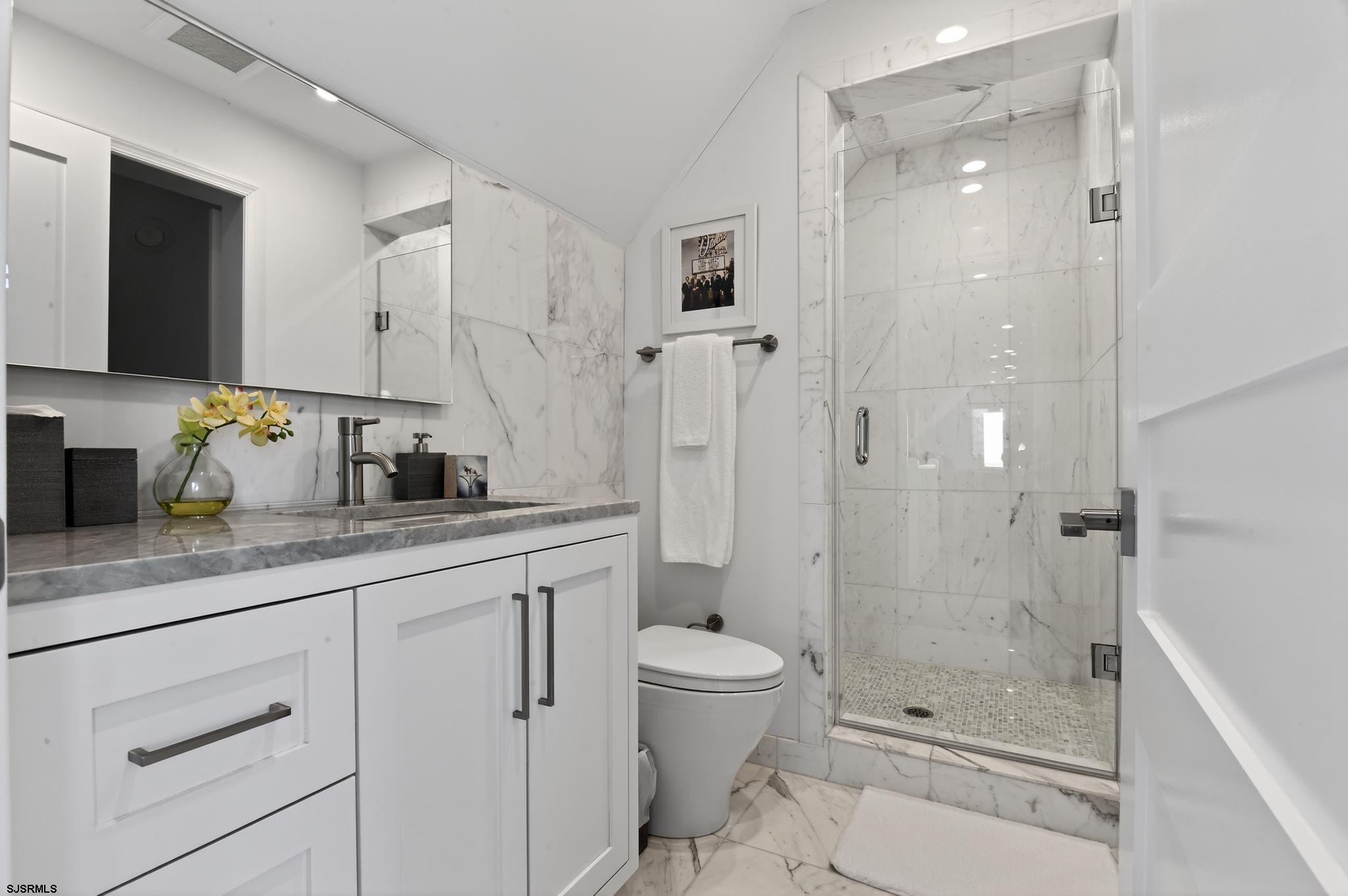 146 Ridgeway Avenue Atlantic City, NJ 08401 - Photo 33 of 59 a bathroom with a granite countertop sink a toilet and shower