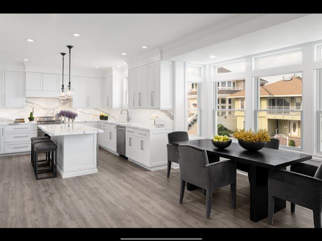 146 Ridgeway Avenue Atlantic City, NJ 08401 - Photo 7 of 59 a open dining room with kitchen island stainless steel appliances wooden floor a table and chairs