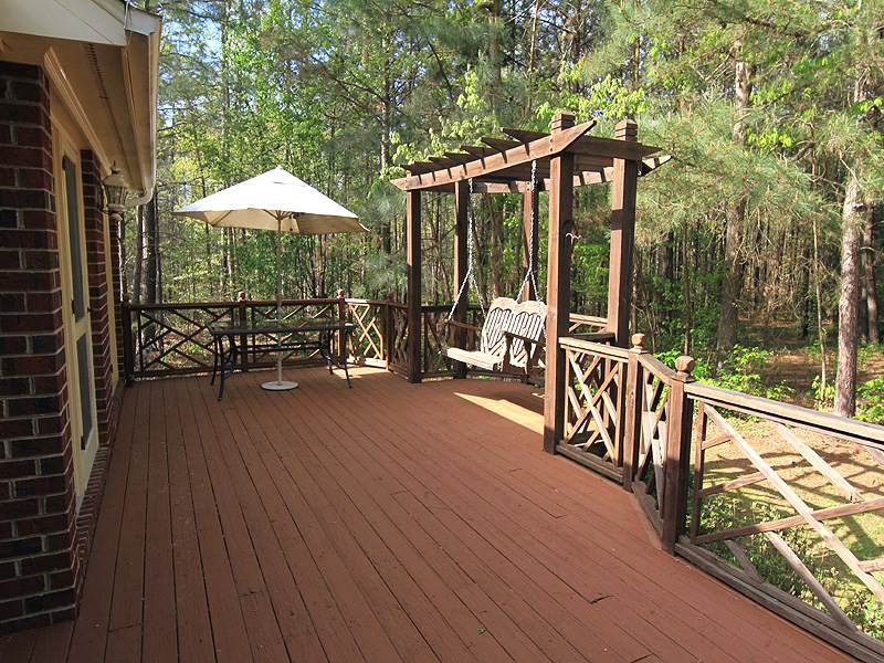 4117 Lassiter Road Wake Forest, NC 27587 - Photo 13 of 22 Relax and unwind on the built in deck swing. Patio/Deck