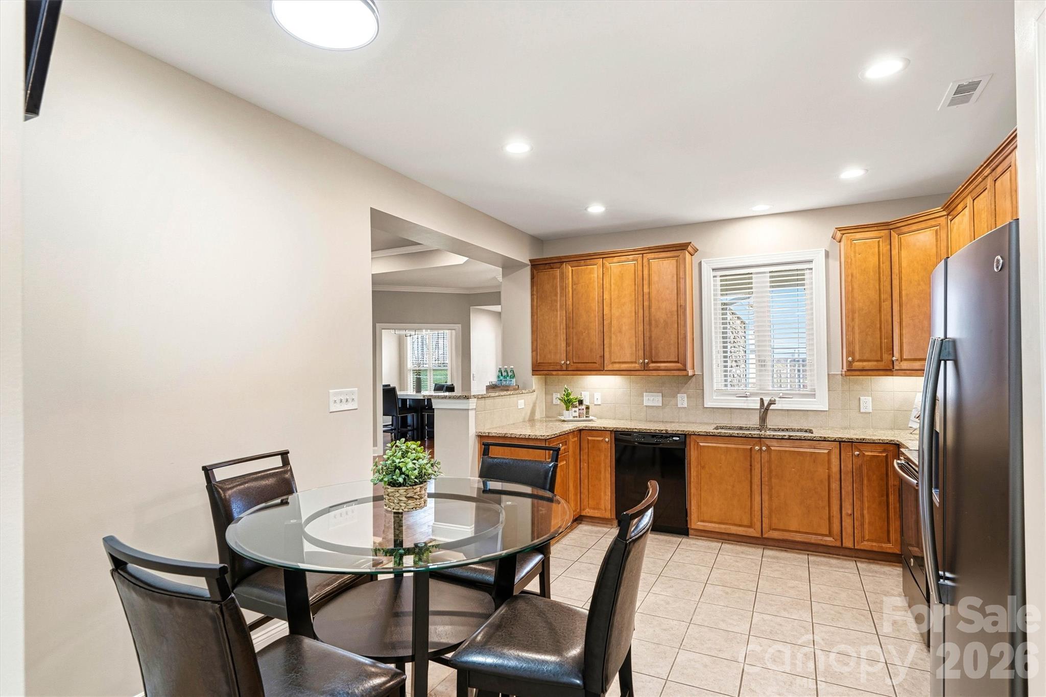 2830 Bellasera Way Matthews, NC 28105 - Photo 11 of 40 a view of a dining room with furniture window and wooden floor