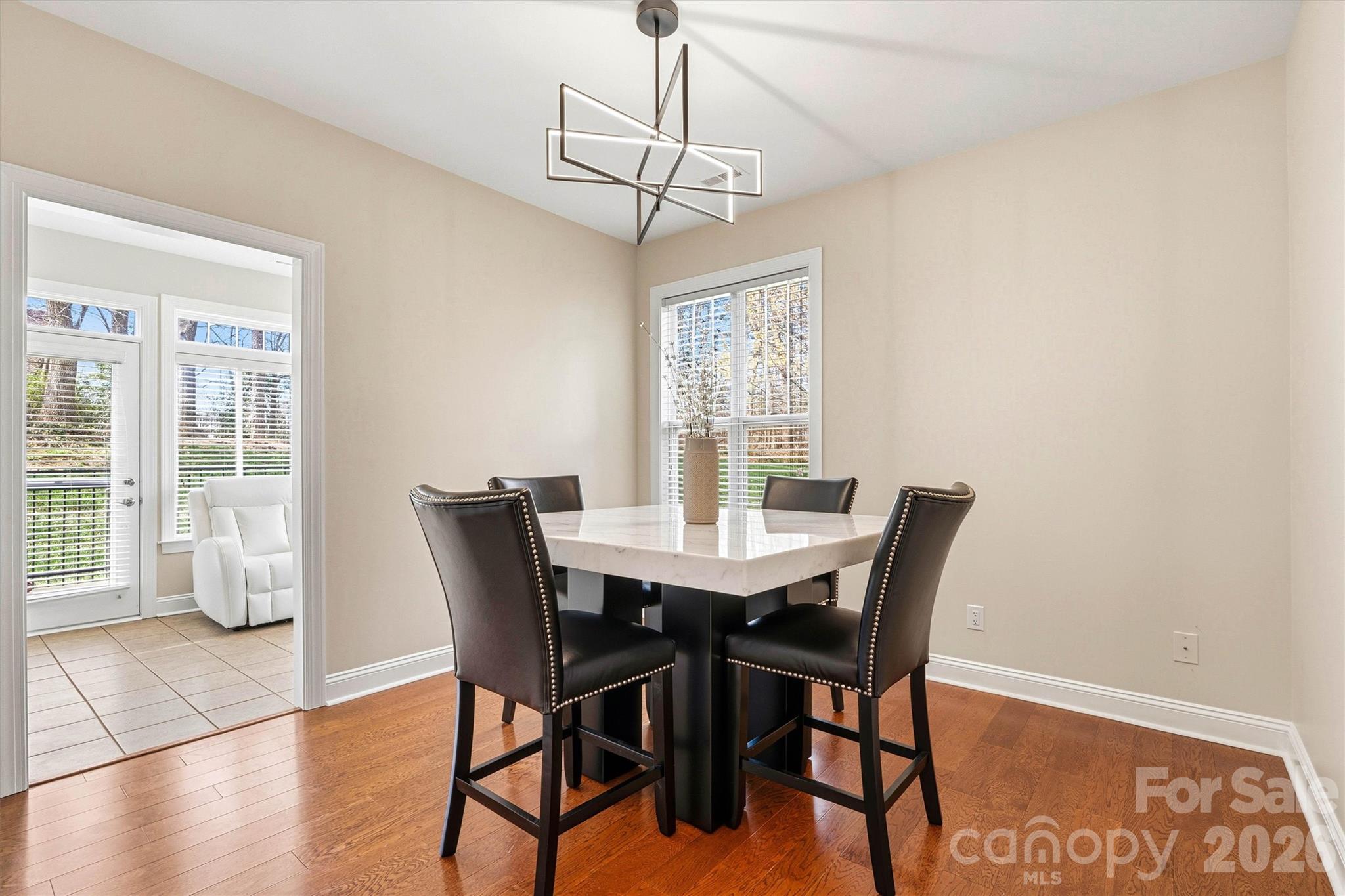 2830 Bellasera Way Matthews, NC 28105 - Photo 15 of 40 a view of a dining room with furniture window and wooden floor