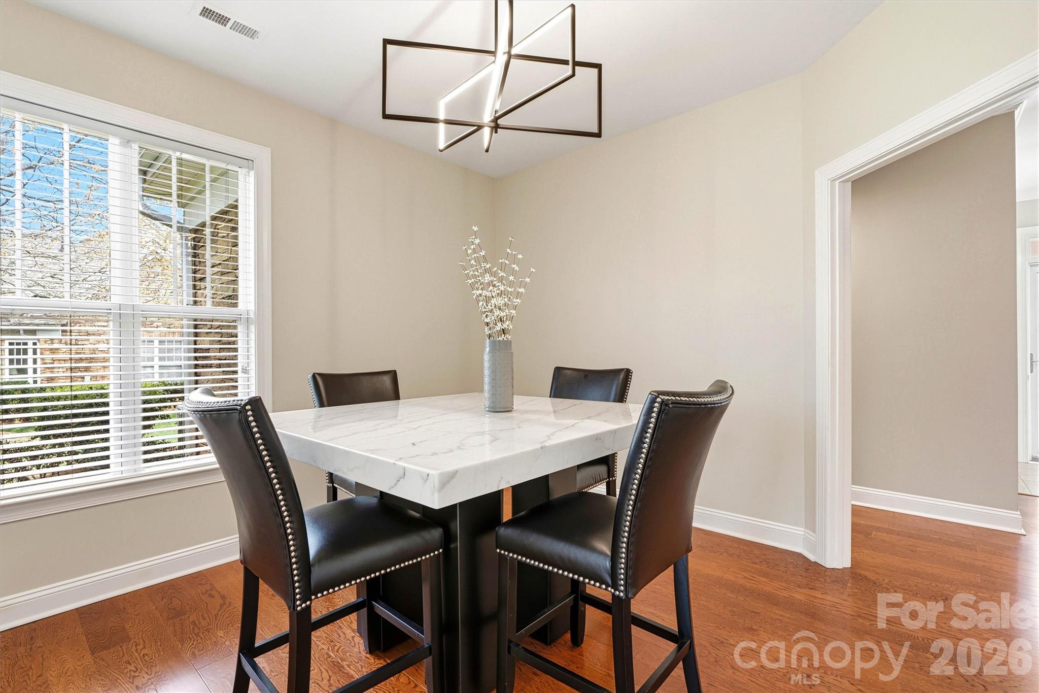 2830 Bellasera Way Matthews, NC 28105 - Photo 17 of 40 a view of a dining room with furniture and wooden floor