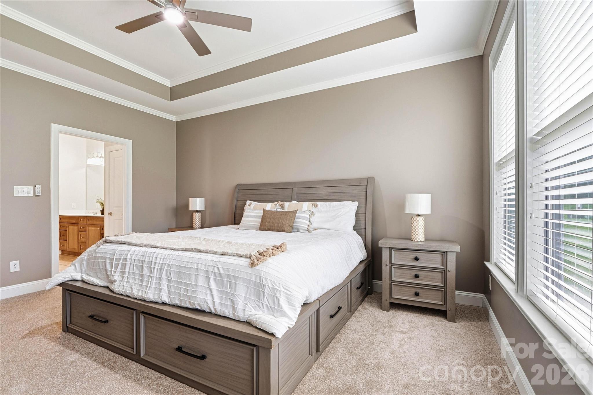 2830 Bellasera Way Matthews, NC 28105 - Photo 20 of 40 a bedroom with a bed and a chandelier