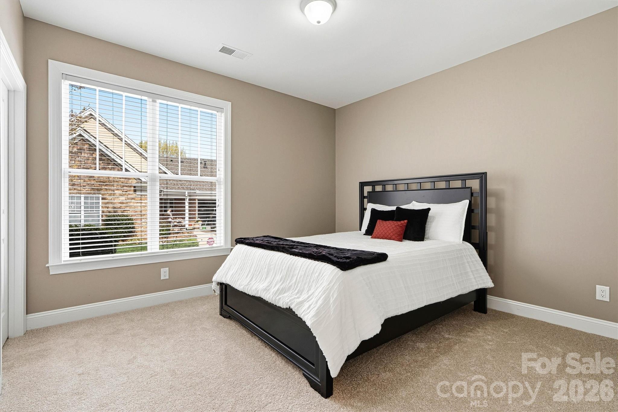 2830 Bellasera Way Matthews, NC 28105 - Photo 26 of 40 a bed sitting in a bedroom next to a window