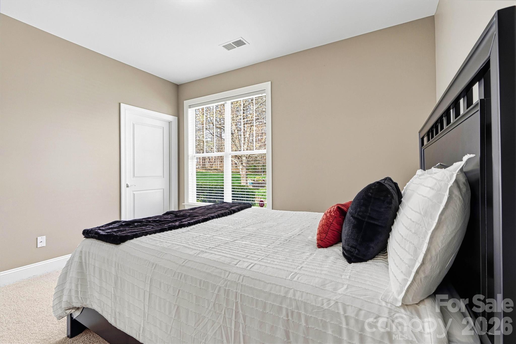 2830 Bellasera Way Matthews, NC 28105 - Photo 28 of 40 a bedroom with a bed and a large window